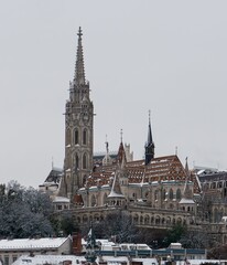 Obraz premium Fisherman's Bastion next to the Danube River in Budapest covered with the first snow