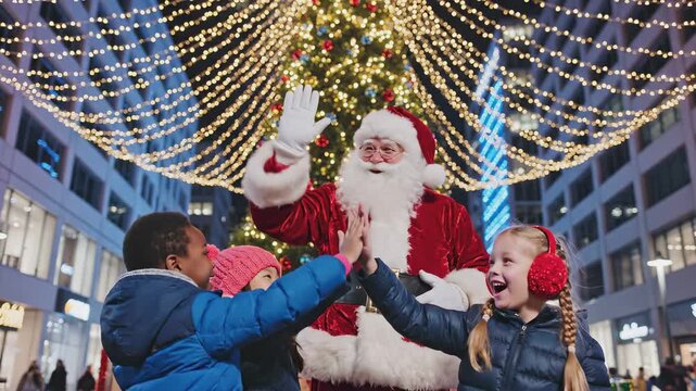 Joyful children celebrate with Santa Claus in festive holiday scene, exchanging high-fives under twinkling lights, camera captures dynamic interaction