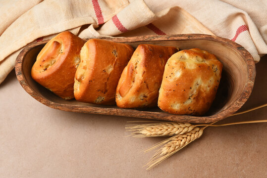 Food Still Life. Onion Chibatta rolls is a wood serving boat with wheat stalks and tea towel