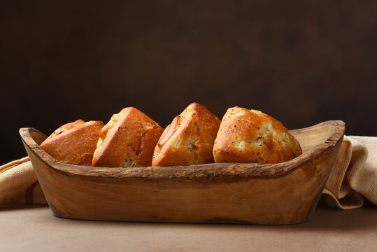 Food Still Life. Onion Chibatta rolls on a wood serving boat with a warm brown background.