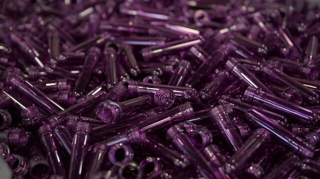 Purple PET preforms for plastic bottle manufacturing process.