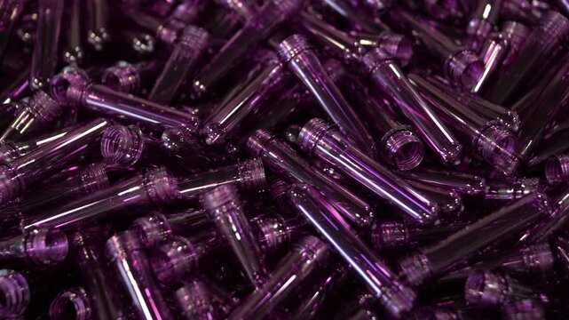 Purple PET preforms for plastic bottle manufacturing process.