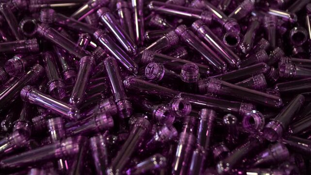 Purple PET preforms for plastic bottle manufacturing process.