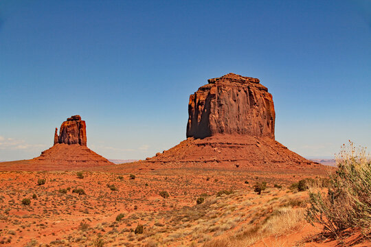 Merrick Butte and East Mitten in Monument Valley Tribal Park within the Navajo Nation which is in both Utah and Arizona, USA with blue sky copy space.
