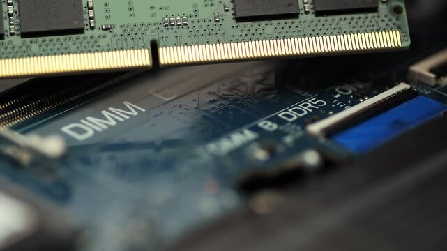 DDR5 RAM module held above motherboard slot before installation