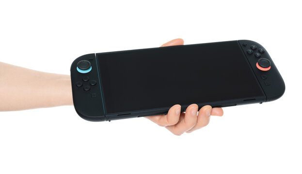 Hand holding Nintendo Switch 2 gaming console, isolated on transparent background