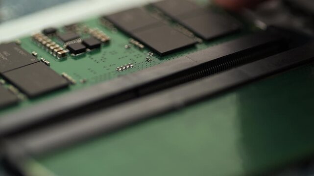 DDR5 RAM module sliding out of motherboard slot in close up
