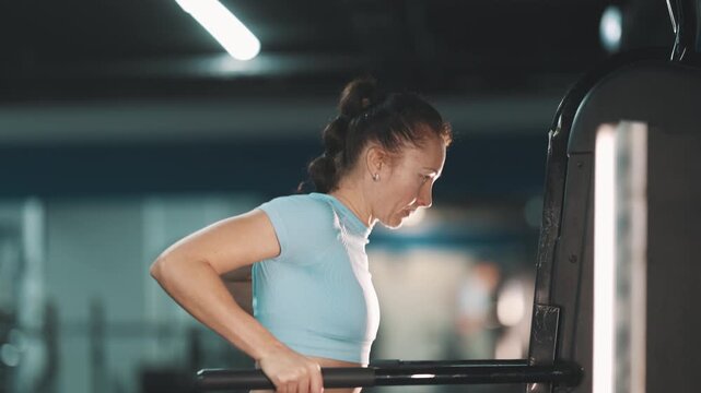 Determined athletic woman doing triceps dips
