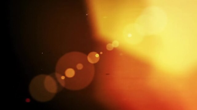 Abstract fluid motion video with cinematic light leaks, soft ethereal lens flares, and analog grain, featuring red, orange, yellow hues and creamy bokeh. Timeless mesmerizing flow