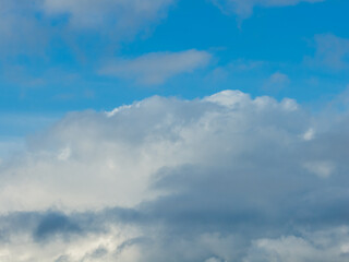Obraz premium Clear Blue Sky With Soft White Clouds Over a Calm Horizon Above Howe Sound, BC