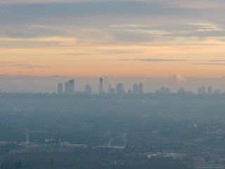 Fototapeta premium Mist Shrouded City Skyline at Sunrise Over Burnaby, BC, Canada