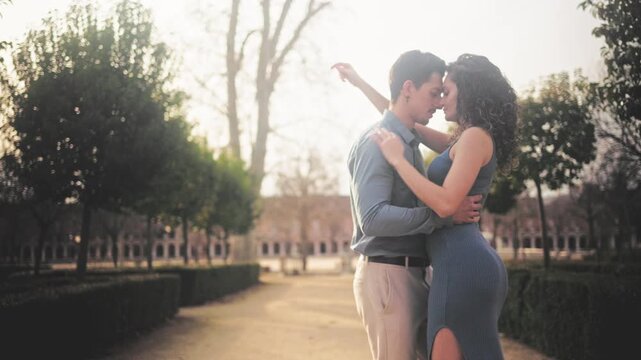 Romantic hispanic couple dancing sensual bachata in a park