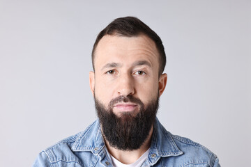 Obraz premium Man with mustache and beard on light grey background