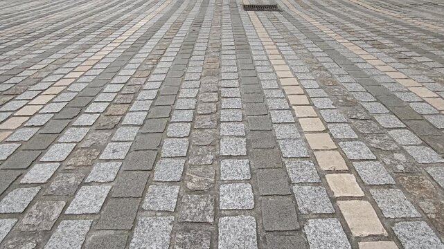 Closeup of feet walking on stone block paving