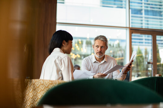 Business professionals reviewing documents at cafe