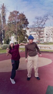 Hispanic female dancer freestyling while a woman beatboxes