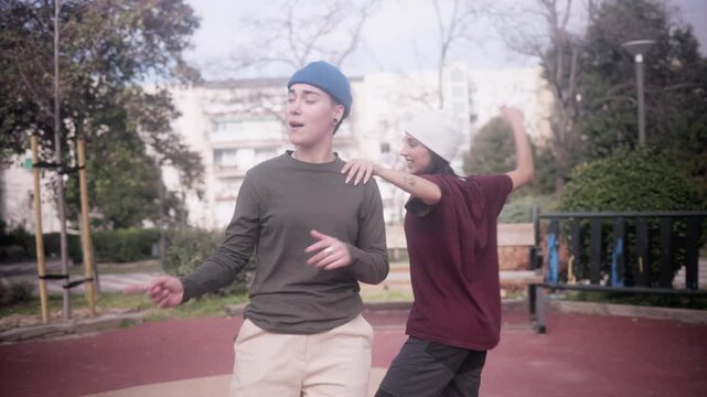 Urban dancer and beatboxer performing hip hop freestyle in a park