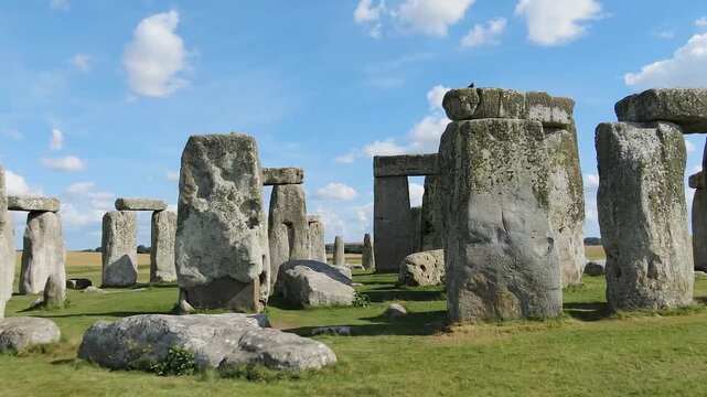 Majestic Stonehenge prehistoric monument under a bright blue sky in Wiltshire, England