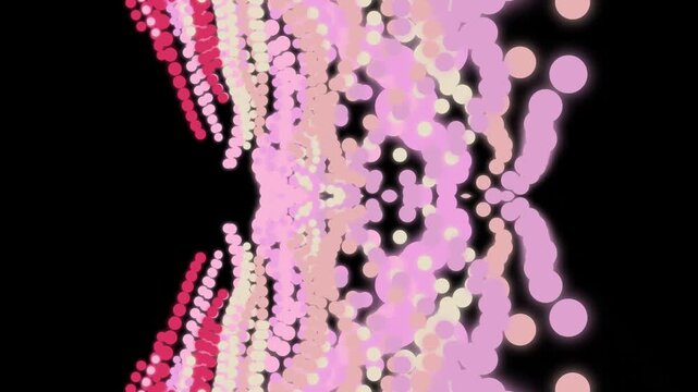 Vibrant pink and red beads scattered on a black background with a white surface in the foreground.