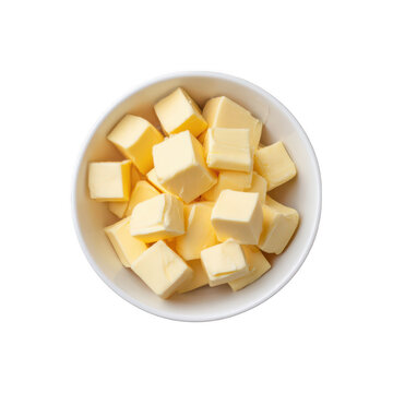Diced butter cubes in a white bowl, top view, representing dairy ingredients for baking and cooking