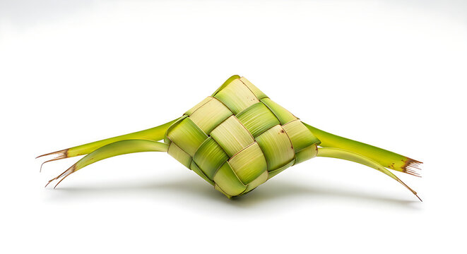 A small woven ketupat ornament in natural palm leaf texture, isolated on clean white surface
