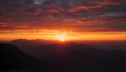 Obraz premium sunset over majestic mountain range with dramatic golden sky