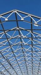 Metal Greenhouse Structure Under Blue Sky.