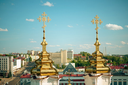 Golden domes of Holy Resurrection Church against blue sky in Vitebsk, Belarus.