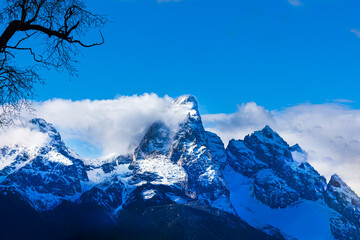 Grand teton mountains with wind blowng snow off the top
