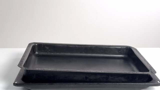 Video with real sound effect of Metal trays stacking clangingl