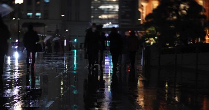 A night cityscape of the rainy urban street at the business town in Tokyo