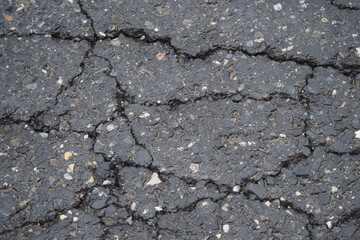 Obraz premium Daytime cracks on urban asphalt surface