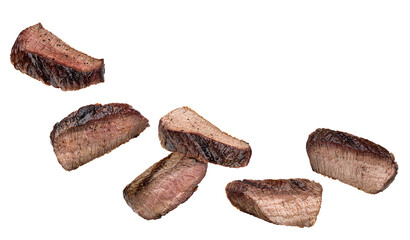 Obraz premium collection of sliced, cooked steak pieces, displaying a perfectly seared exterior and tender, pink center, set against black.