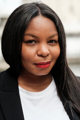 Confident businesswoman smiling outdoors, urban portrait