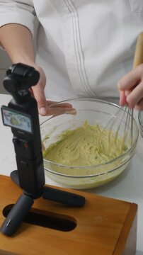 Food Content Creator Recording Cooking Video with Action Camera and Studio Lighting Setup