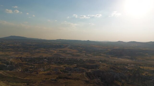 Goreme, Nevsehir, Turkey. Summer evening panoramic drone view over Cappadocia plateau showing mountains, fields and sunset light in Goreme National Park. Aerial View, MasterShots, MasterShots, Panora
