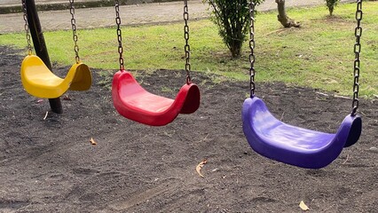 Colorful Swings in Public Playground for Children Activities