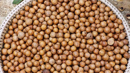 Unshelled macadamia nuts, close up textures.