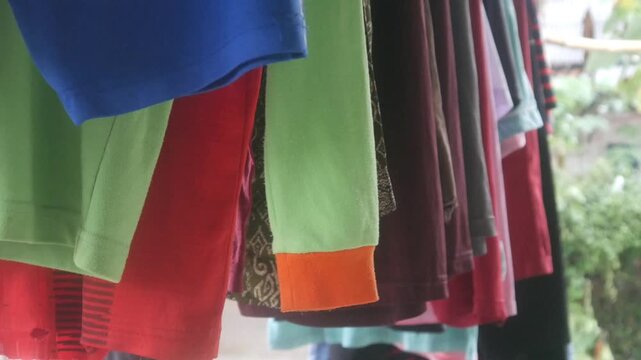 Rows of colorful clothes hanging on an outdoor clothesline