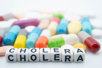 Cholera word with pills and capsules medical drug.
