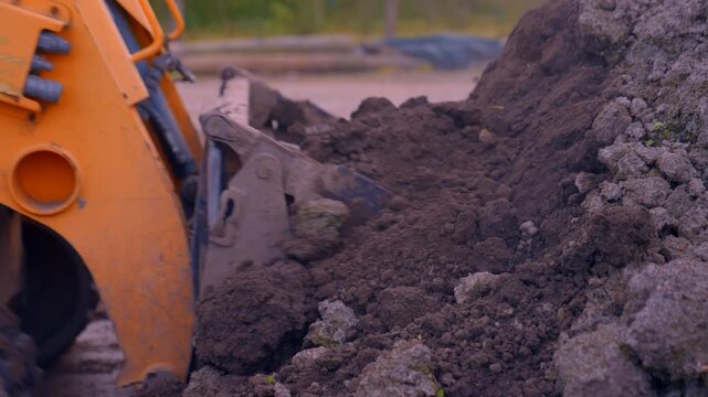 Nutrient rick soil scooped on a fruit orchard