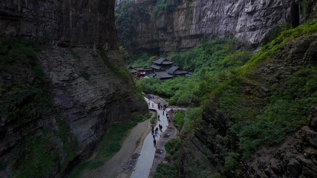 Tourists Walking Along The Trail Towards The Tianfu Official Post In The Wulong Karst National Geology Park In Chongqing, China. - aerial shot