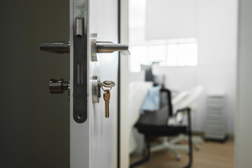 door is open with a key hanging from the door handle