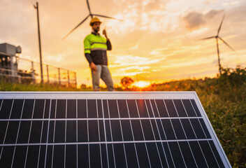 man is standing in front of a solar panel
