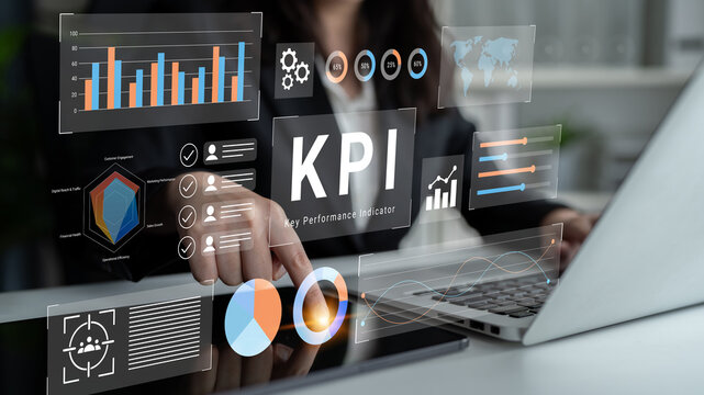 A focused business professional analyzing digital key performance indicators on a laptop screen surrounded by various informative graphs and charts in a modern office setup. Gantry