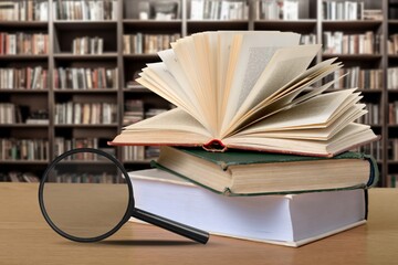 Old books and magnifying glass, history, education concept