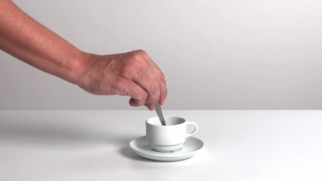 Video with real sound effect of Metal spoon stirring in ceramic cup