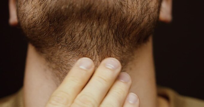 Close-up of a man&rsquo;s unshaved beard and neck without clean contours. Concept of grooming, personal care, beard growth, masculinity, and everyday appearance.