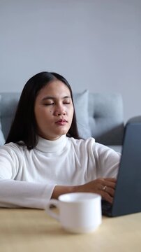 Beautiful Asian Woman feeling tired and yawning, battles fatigue and boredom