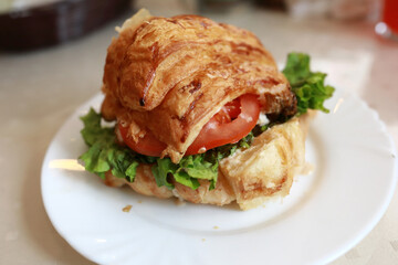 Croissant sandwich with chicken, lettuce, tomato